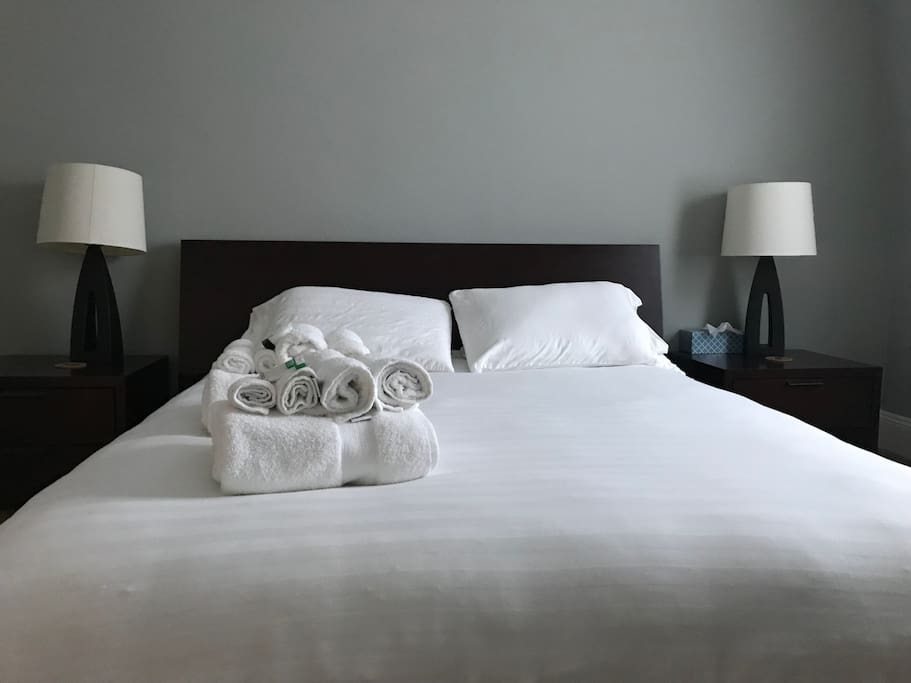 Spotless bedroom with fabulous clean linens, towels, shampoo, luggage rack, soap and lotion ready for your arrival.
