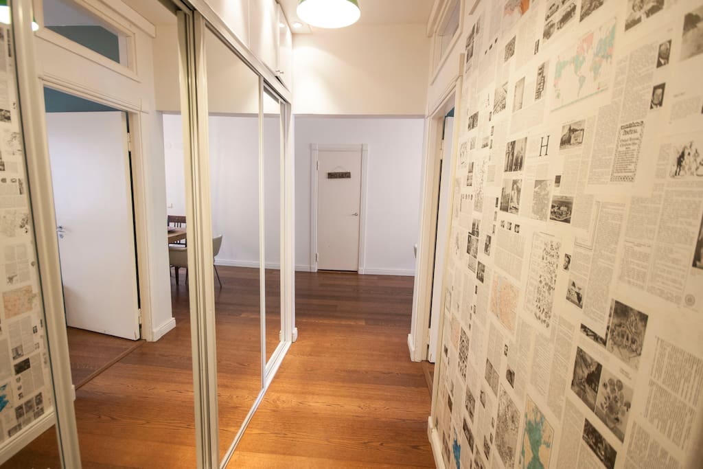Entrance hall with a unique wall paper made out of old book pages.