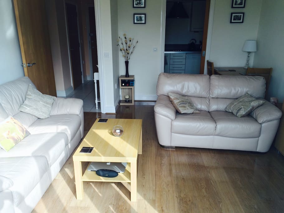 Living room from a different angle - showing the dining area and kitchen.