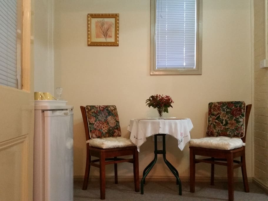 Queen Victoria Suite Sitting room with cafe style setting, cutlery, microwave, toaster, fridge etc