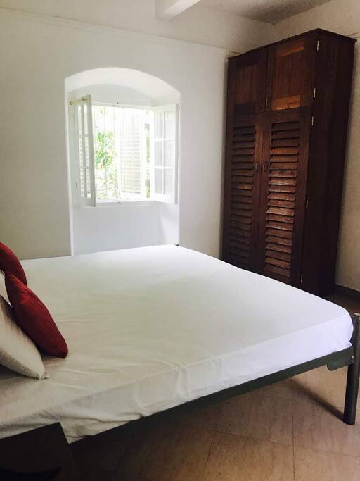 Master bedroom with a closet and 3 perfectly situated windows to get that bright island light