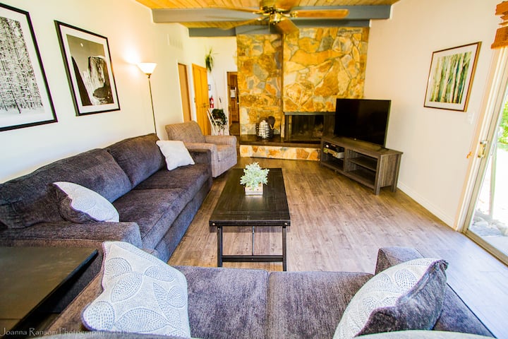 Living room features slate fireplace and ample seating.