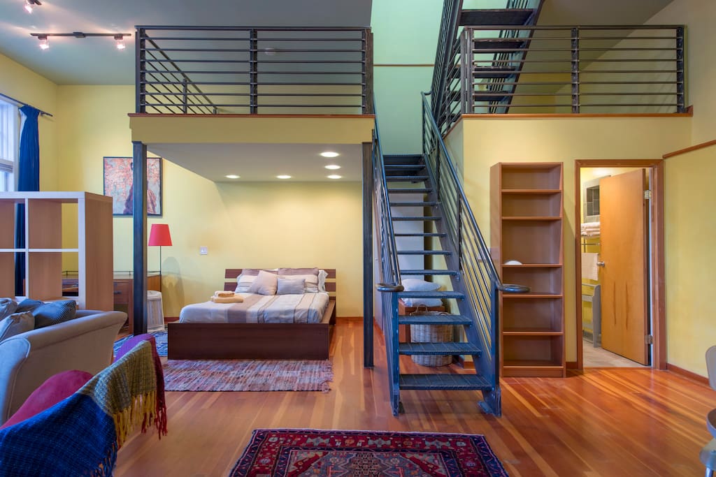 A metal staircase leads to two nooks overlooking the loft.