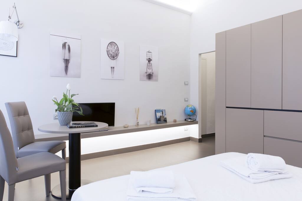 The bedroom (equipped kitchen & dining table, TV)