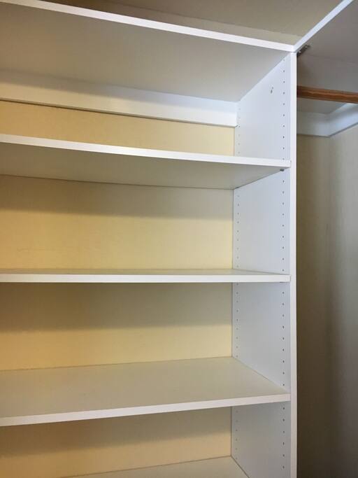 Spacious closet with shelving and two hanging areas