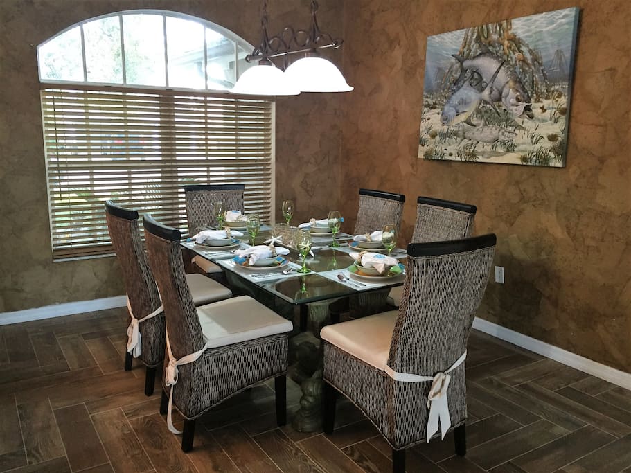 Formal dining room with seating for 6. Decorated in tropical theme.
