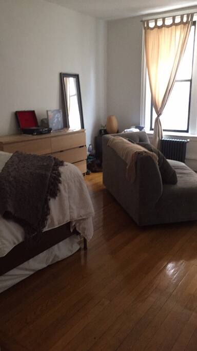Room with full bed and couch