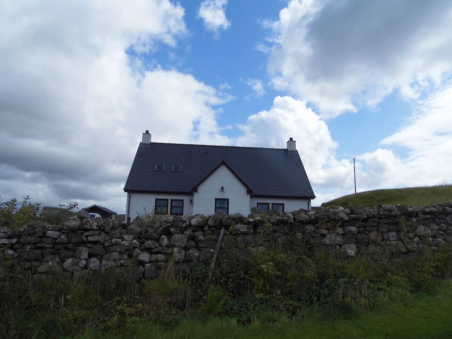 Ornum from the roadside, traditional stone dyke in the foreground