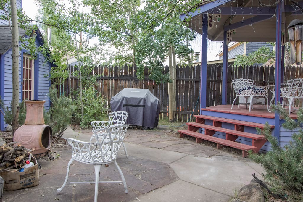 Courtyard area with fire pit, wood, and gas grill.