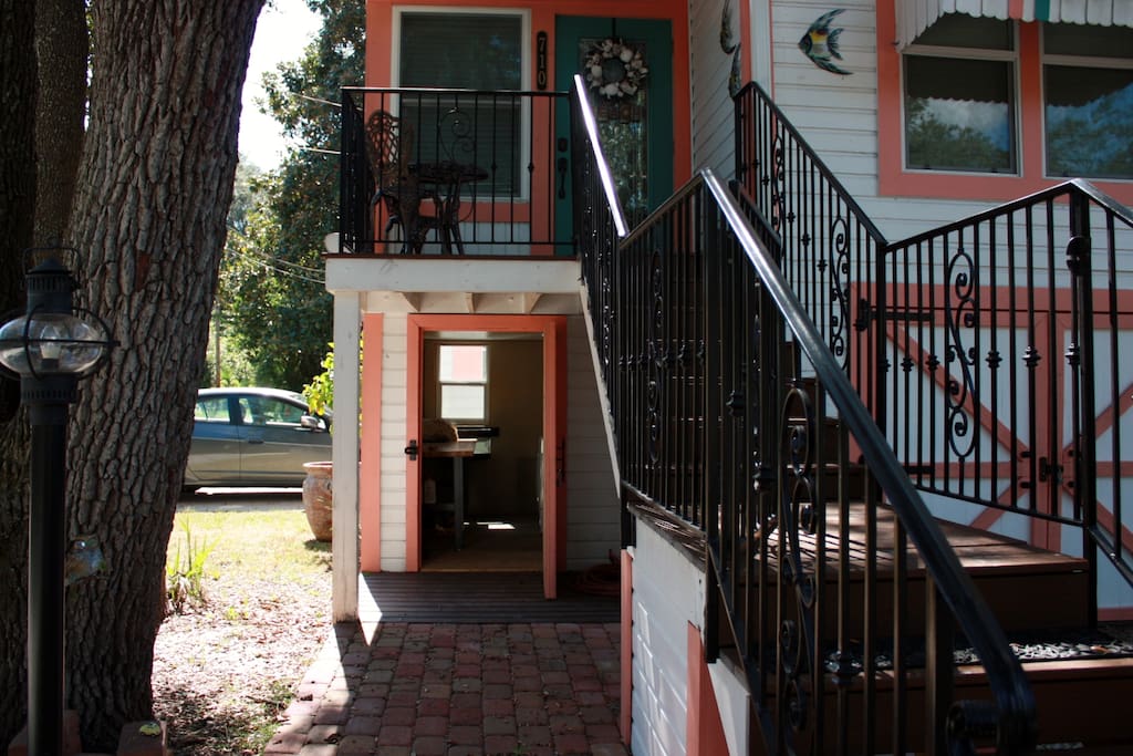 Iron handrails lead to the quaint porch and entrance