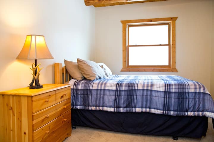 This first floor bedroom is furnished with a pillow top mattress and gives privacy to its occupants. A nearby full bath is very convenient. 