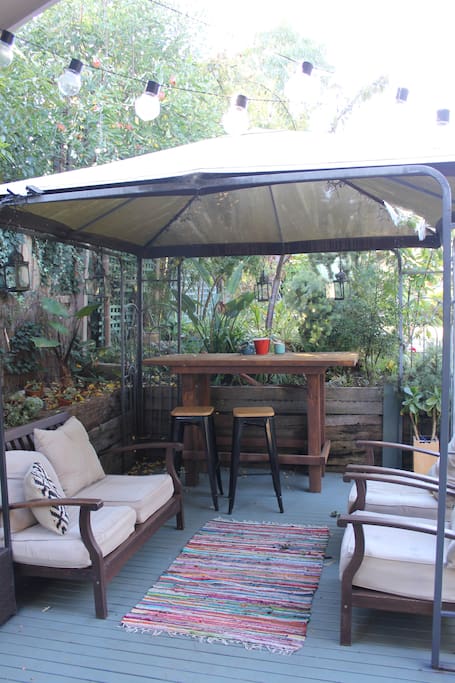 Downstairs permanent marque with seating, nestled in the garden