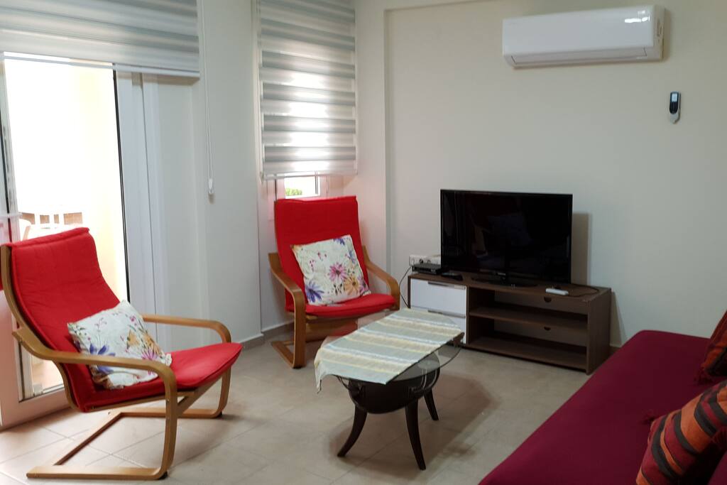 lounge with coffee table, blinds and french door leading to balcony
