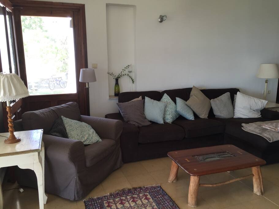 The living room has s large comfy sofa and an armchair.