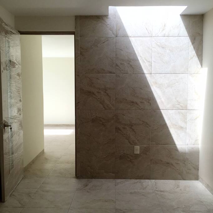 Architecturally designed sky light above bed in one of the three bedrooms.