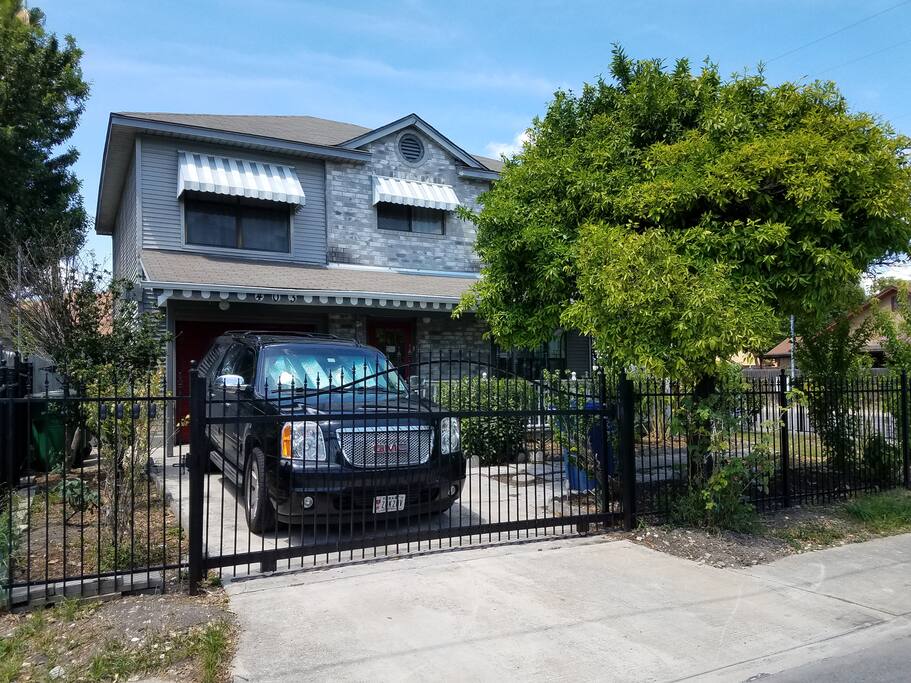 Driveway. Key lockboxes are located to the left of the driveway gate.