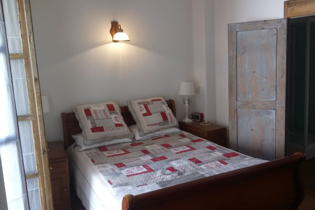 1st main bedroom with large ensuite, armoire, mirrors and french doors that open to sunny terrace.