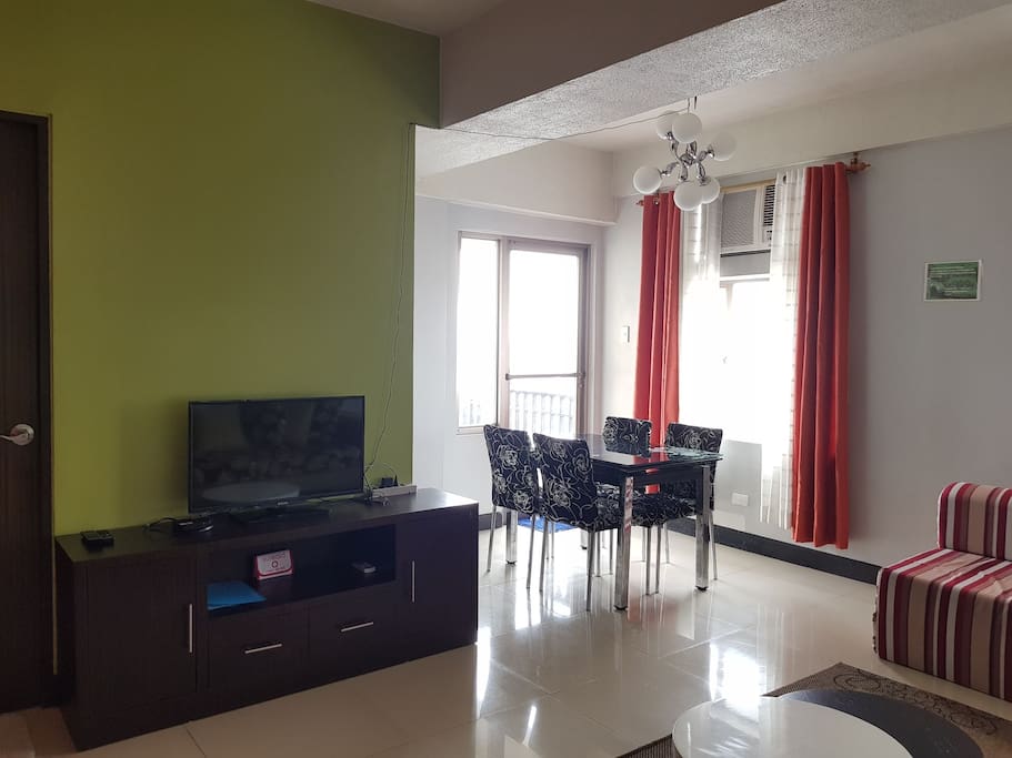 Other Half of the Living Room area:
- TV
- ABS-CBN TV Plus
- AC Unit
- Expandable Dining Table
- 4 Chairs
- First Aid Kit
