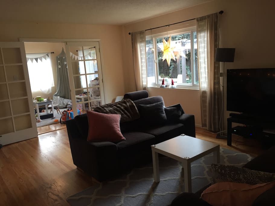 Living room with TV (play room in background)