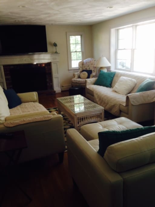 Family Room with new leather furnishings, chaise, and large HDTV.