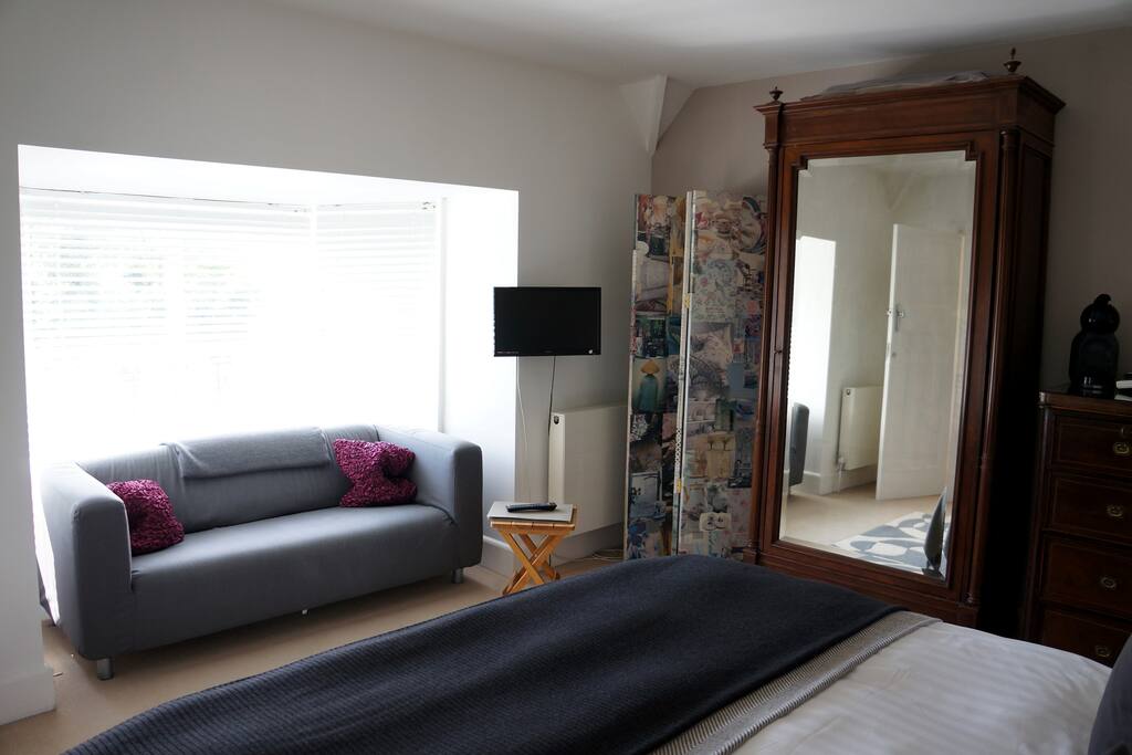 T.V., sofa and over looks main garden, quiet room with en-suite.