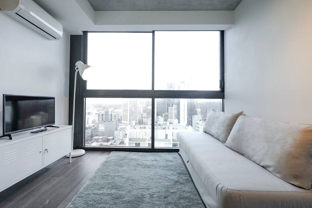 Well-lit living room for enjoying your afternoon. It has stunning view at night too.