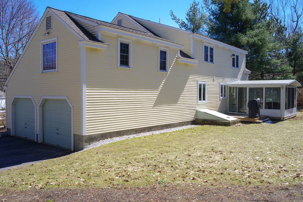 Back of the house - grill on patio with sunporch.