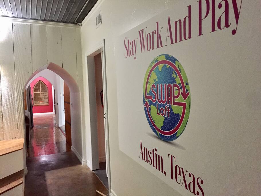 Front entrance - movie room to the right, CoWorking ahead of you and kitchen and conference room beyond that.