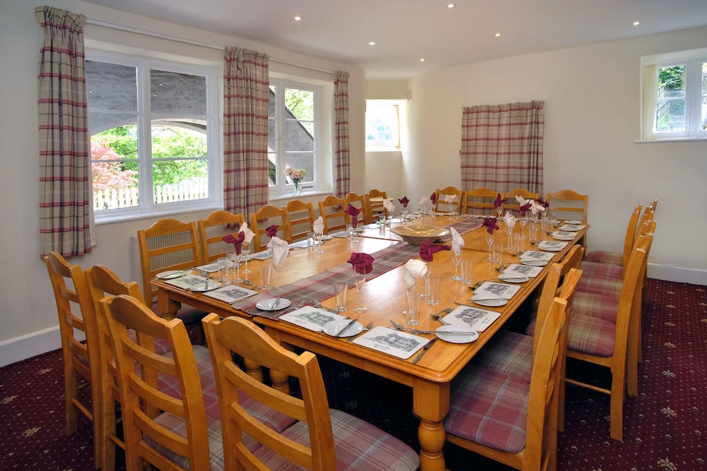 The dining room seating up to 24 guests adjacent to the kitchen