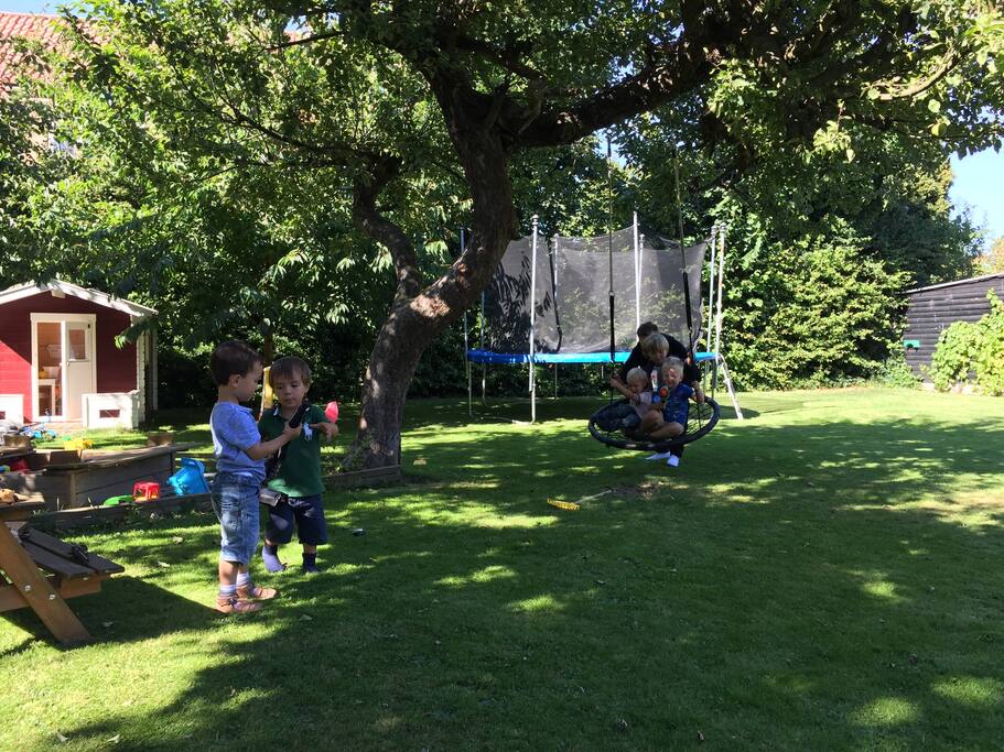 Our garden with a playhouse, trampoline, sand box etc.
