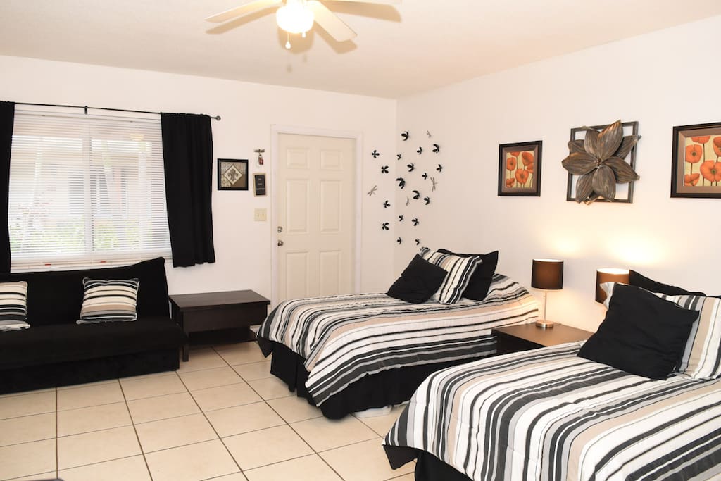 Sleeping and sitting area with view of patio, shown with beds in "Twin" configuration.