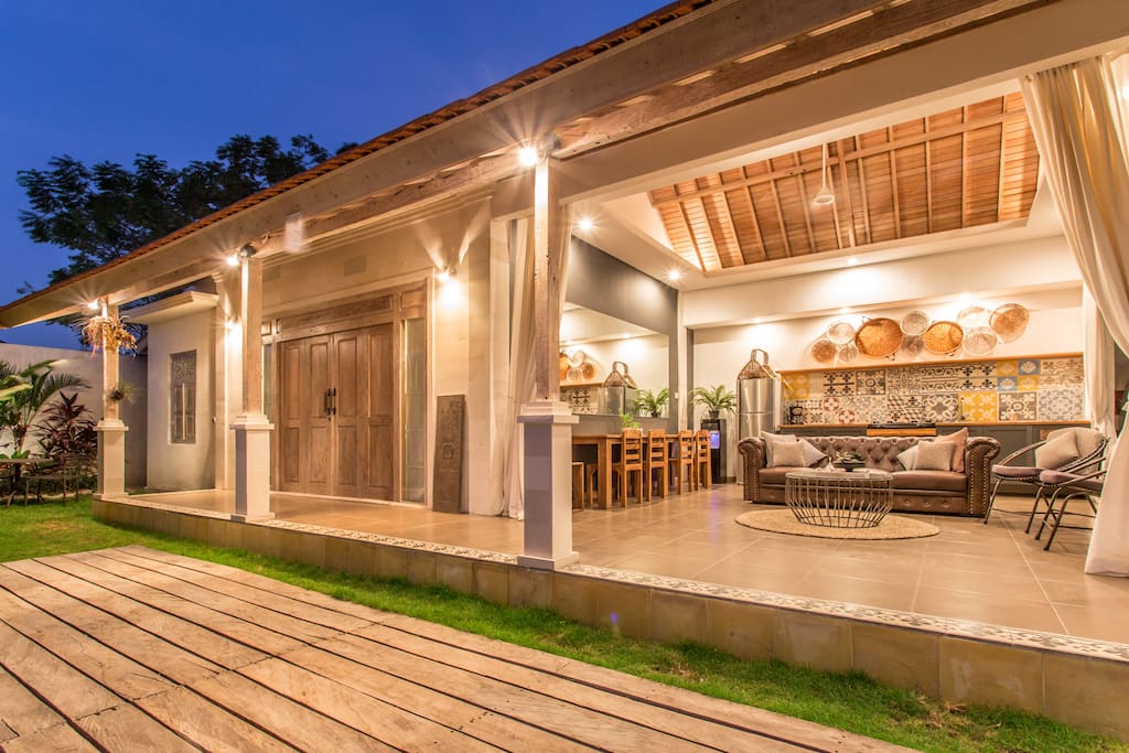 Open style lounge, kitchen, and dining room overlooking the lush tropical gardens and shimmering swimming pool.