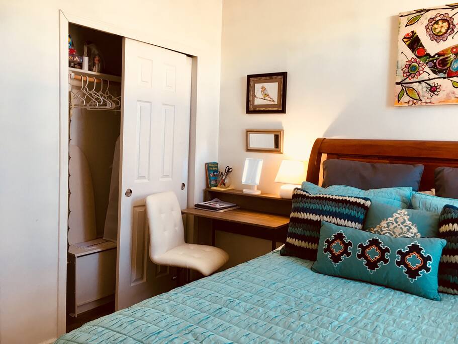 Closet space with extra blankets, iron, games, desk w/chair, area guides, and makeup mirror