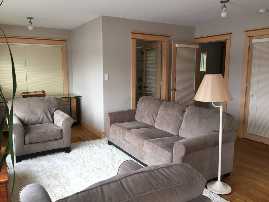 Living room, showing doors to bathroom, bedroom, and entrance way.