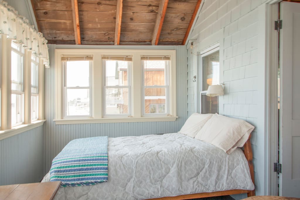Bedroom with full size bed. This room has 12 windows.