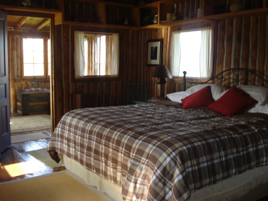 Living area with a large, king sized bed.