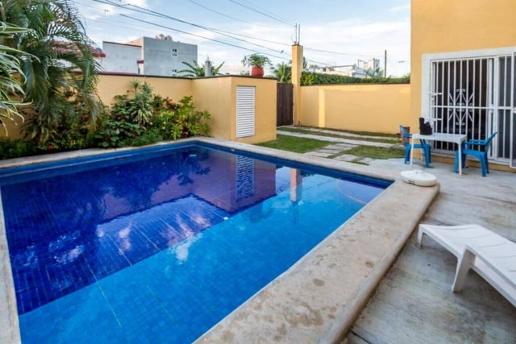 Backyard has a large pool and BBQ grill