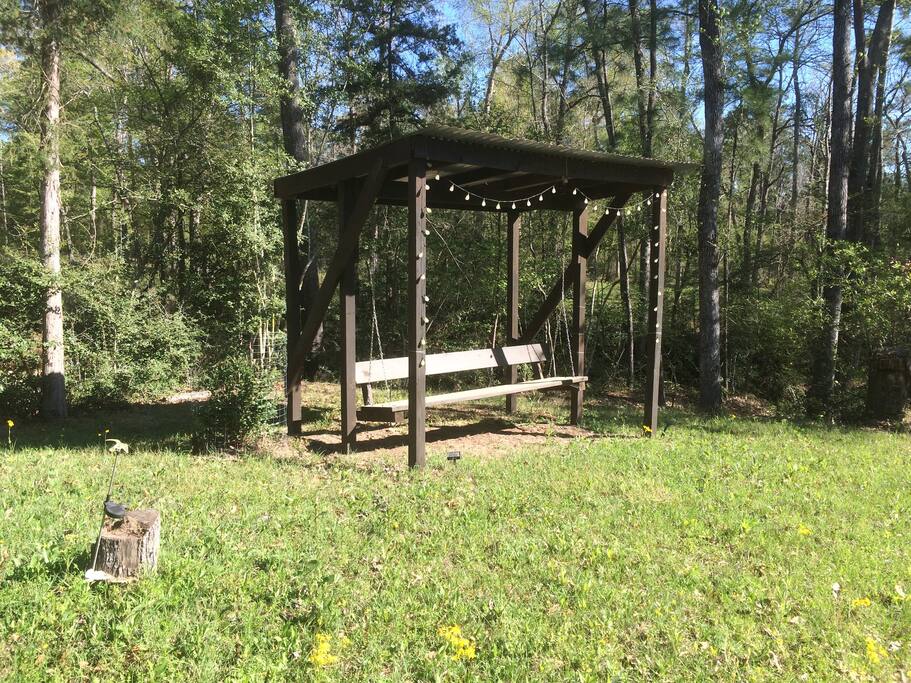 Bench swing next to pond
