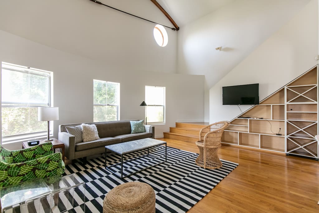 Living room with stairs up to 3rd floor bedroom.