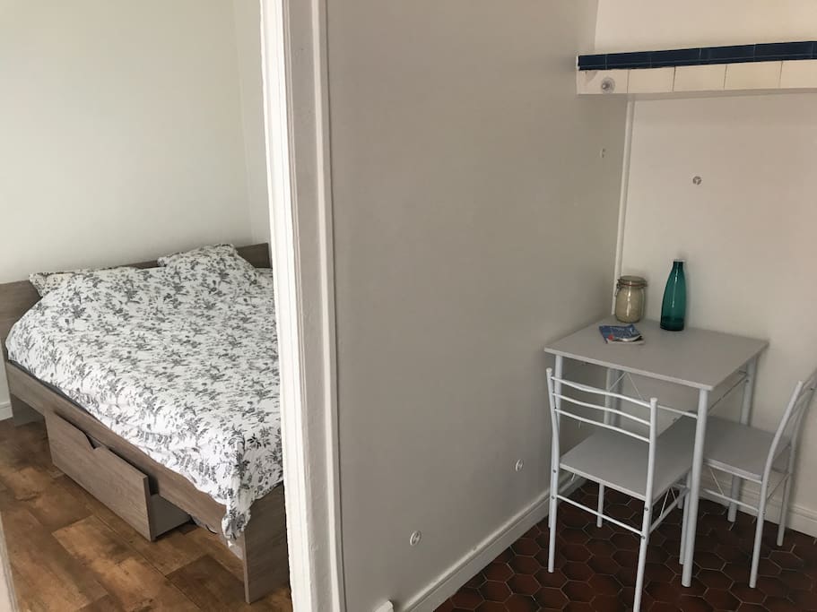 Room next to the kitchen. Table and two sits.