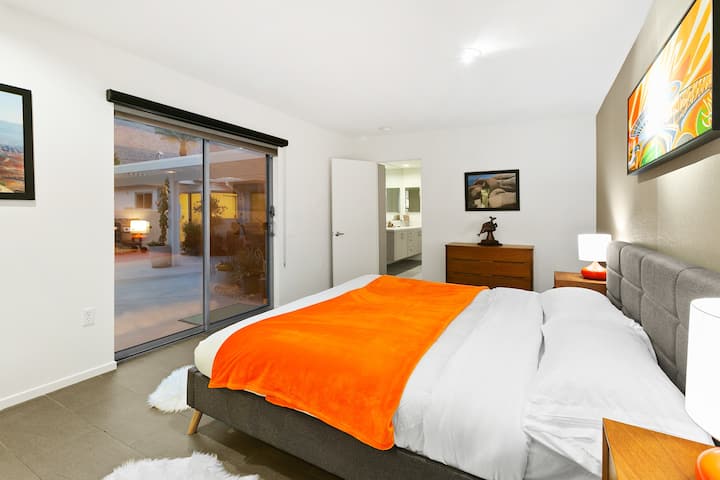 Master bedroom with mountain views from the bed and exit to pool