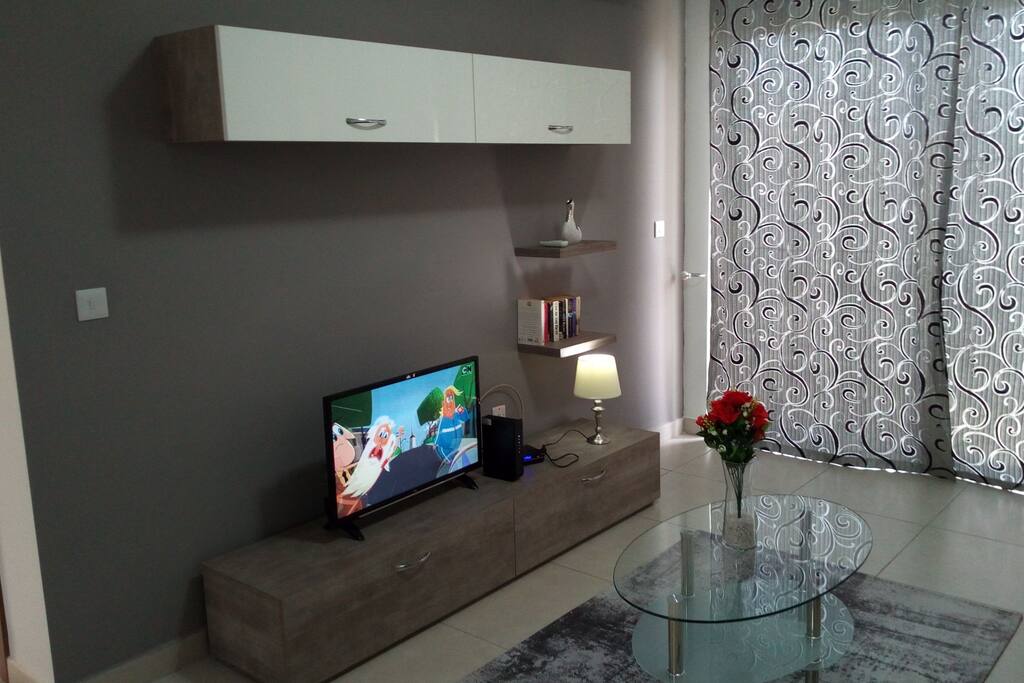 Living room area with curtains closed.