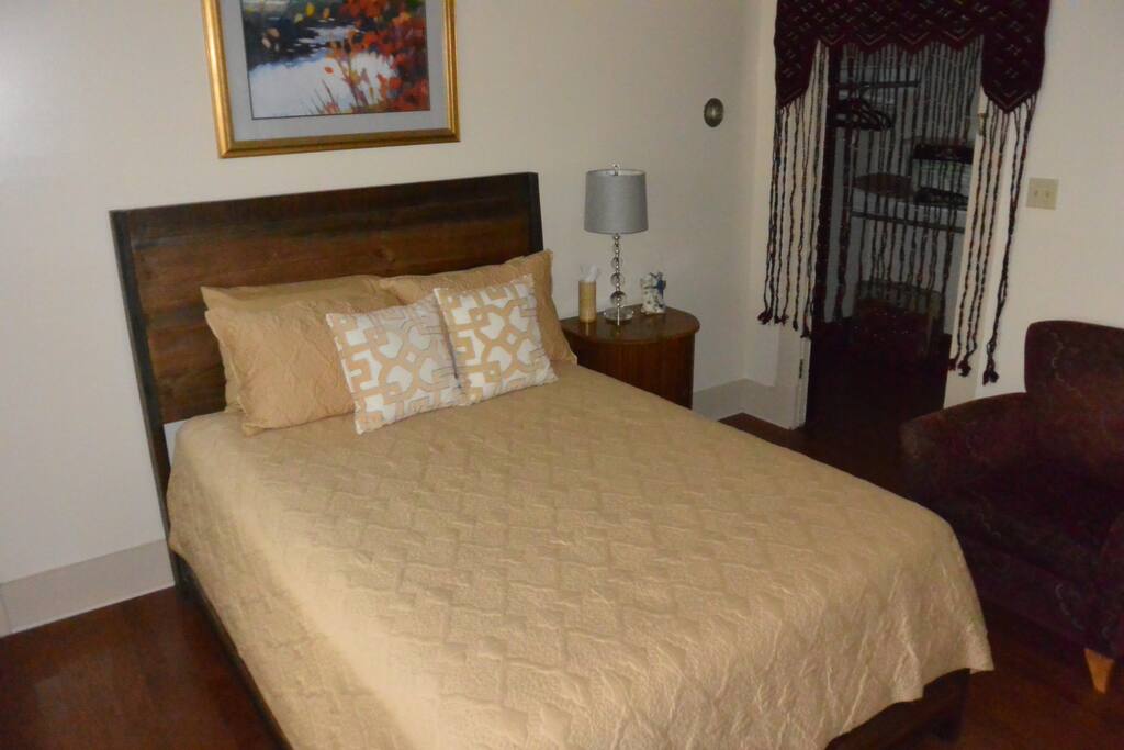 Queen-sized bed in private room.