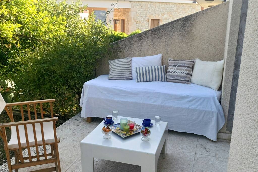 GF veranda w. sitting area in front of the villa
