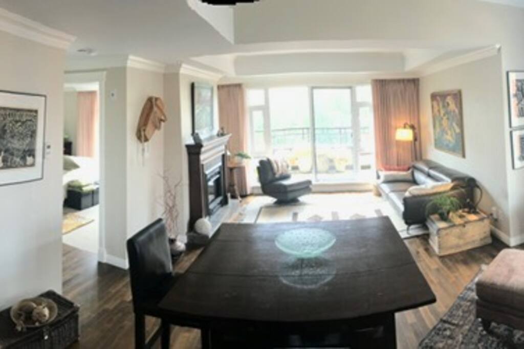 Spacious living room with gas fireplace, TV, and walk on deck