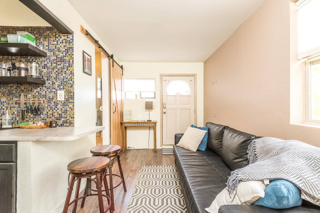 The kitchen is recently remodeled with a mosaic backsplash and breakfast bar.