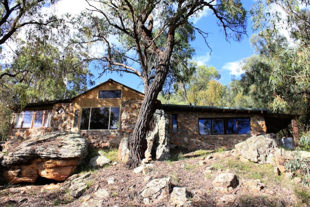our house - local sand stone blends into the bush