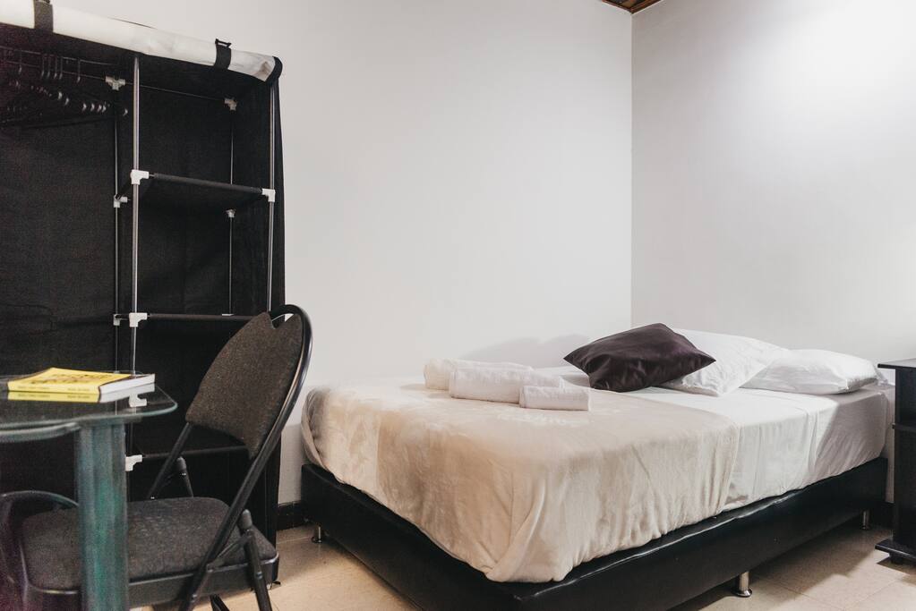 Your private bedroom with double bed, desk/workspace, closet, lamp, night stand.