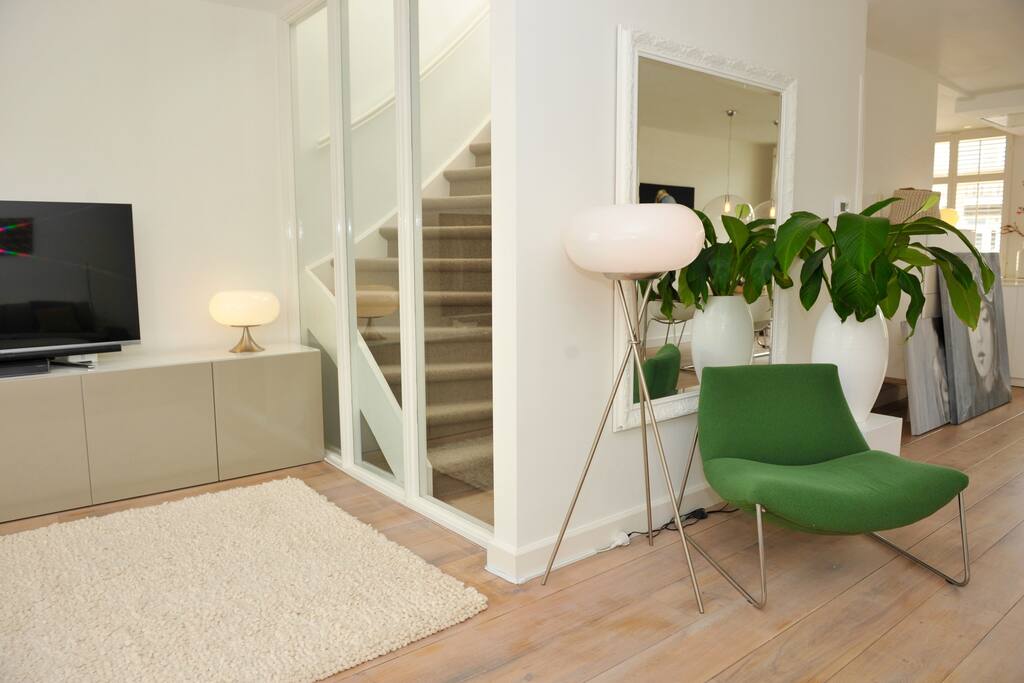 Television and the stairs to the bedroom and bathroom floor.