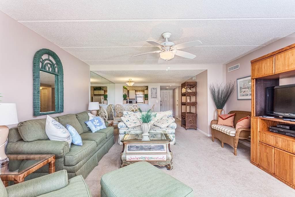 Watch HDTV from the comfort of our beach front condo! - Our cushiony sofa is not only great for sitting, but also for sleeping. O